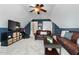 Comfortable living room boasts a ceiling fan, vaulted ceilings, and storage at 7252 Bedford Ridge Dr, Apex, NC 27539