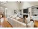 Cozy living room with hardwood floors, fireplace, built-in shelving, and a comfortable oversized sectional sofa at 7252 Bedford Ridge Dr, Apex, NC 27539