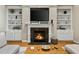 Cozy living room features a fireplace with built-in bookshelves and a stylish mantel with decor at 7252 Bedford Ridge Dr, Apex, NC 27539