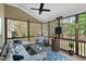 Cozy screened-in patio with comfortable seating, wood floors, and a ceiling fan at 7252 Bedford Ridge Dr, Apex, NC 27539