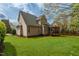 Well-maintained home exterior with a manicured lawn, showcasing the back of the property with a screened porch at 7252 Bedford Ridge Dr, Apex, NC 27539