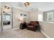 Cozy upstairs sitting area with natural light and a comfortable leather armchair at 7252 Bedford Ridge Dr, Apex, NC 27539