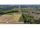 Extensive aerial view of a home and several outbuildings across a large property divided by a central road at 8079 Stone Heritage Rd, Middlesex, NC 27557