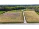 Expansive aerial view of a property with a house, outbuildings, and a long driveway on a large lot at 8079 Stone Heritage Rd, Middlesex, NC 27557