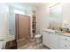 Clean bathroom with shower-tub combo, built-in shelving, and vanity with ample counter space at 8079 Stone Heritage Rd, Middlesex, NC 27557