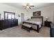 Primary bedroom featuring a dark wooden bed frame, furniture, neutral carpet, and lots of light at 8079 Stone Heritage Rd, Middlesex, NC 27557