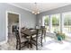 Inviting dining area features a wooden table set, large windows with views, and natural lighting at 8079 Stone Heritage Rd, Middlesex, NC 27557