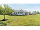 Inviting single-Gathering home with a charming front porch and a lush green lawn extending to the detached garage at 8079 Stone Heritage Rd, Middlesex, NC 27557
