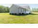 Gray-sided home with a welcoming front porch, complemented by mature landscaping and a well-maintained lawn at 8079 Stone Heritage Rd, Middlesex, NC 27557