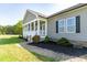 Attractive home with a covered front porch, gray siding, black mulch, and brick pathway enhance curb appeal at 8079 Stone Heritage Rd, Middlesex, NC 27557