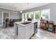 Bright kitchen with an island, stainless steel appliances, granite countertops, and wooden floors at 8079 Stone Heritage Rd, Middlesex, NC 27557