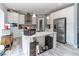 Bright kitchen with an island, stainless steel appliances, granite countertops, and wooden floors at 8079 Stone Heritage Rd, Middlesex, NC 27557