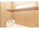 This tiled shower stall has a mosaic tile accent and a window for natural light at 8079 Stone Heritage Rd, Middlesex, NC 27557