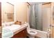 Functional bathroom featuring a shower with curtain, toilet, sink and wood vanity, and neutral colored walls at 8091 Stone Heritage Rd, Middlesex, NC 27557