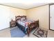 Comfortable bedroom with a wooden bed frame, side table, and neutral-toned walls at 8091 Stone Heritage Rd, Middlesex, NC 27557