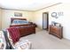 Bedroom featuring a wooden bed frame and dresser on neutral carpeted flooring at 8091 Stone Heritage Rd, Middlesex, NC 27557