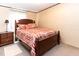 Cozy bedroom featuring a wooden bed frame and a matching nightstand with neutral colored walls at 8091 Stone Heritage Rd, Middlesex, NC 27557