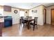 Dining area with a wooden table and chairs adjacent to the kitchen, flooded with natural light at 8091 Stone Heritage Rd, Middlesex, NC 27557