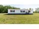 A well-maintained single story home with a charming red roof and white siding with front yard at 8091 Stone Heritage Rd, Middlesex, NC 27557