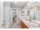 Well-lit bathroom featuring a double vanity, bathtub, and neutral walls, creating a clean and inviting space at 8300 Clarks Branch Dr, Raleigh, NC 27613