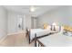 Charming bedroom with two twin beds, a ceiling fan, and neutral decor, creating a warm and inviting space at 8300 Clarks Branch Dr, Raleigh, NC 27613