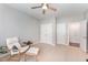 Relaxing bedroom with a ceiling fan, comfortable chair, and neutral decor for a serene ambiance at 8300 Clarks Branch Dr, Raleigh, NC 27613