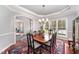 Formal dining room with a chandelier, large window, and classic décor at 8300 Clarks Branch Dr, Raleigh, NC 27613