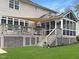Back exterior view of the home featuring a spacious deck and screened in porch at 8300 Clarks Branch Dr, Raleigh, NC 27613