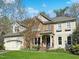 Charming home featuring a mix of stone and shingle siding with a well-manicured lawn at 8300 Clarks Branch Dr, Raleigh, NC 27613