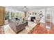 Cozy living room with a fireplace, built-in shelves, and large windows at 8300 Clarks Branch Dr, Raleigh, NC 27613