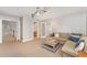 Comfortable living room featuring a cozy sofa and easy access to a full bathroom and stairs at 8300 Clarks Branch Dr, Raleigh, NC 27613