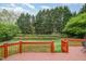 Serene backyard with lush greenery, a wooden deck, mature trees, and a private outdoor space at 9201 Club Hill Dr, Raleigh, NC 27617