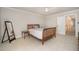 A cozy bedroom with soft carpeting, a decorative wood bed frame, and a full-length mirror at 9201 Club Hill Dr, Raleigh, NC 27617