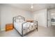 Inviting bedroom with a wrought iron bed frame, ceiling fan, and double door closet for ample storage at 9201 Club Hill Dr, Raleigh, NC 27617
