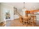 Bright dining area with hardwood floors and direct access to an outdoor patio and modern kitchen at 9201 Club Hill Dr, Raleigh, NC 27617