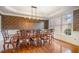 Elegant dining room with hardwood floors, decorative wallpaper and ample natural light at 9201 Club Hill Dr, Raleigh, NC 27617