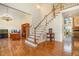 Spacious foyer with hardwood floors, a grand staircase, and elegant decor at 9201 Club Hill Dr, Raleigh, NC 27617