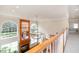 A spacious foyer with a grand chandelier, showcasing a fireplace and large, arched windows for abundant natural light at 9201 Club Hill Dr, Raleigh, NC 27617