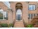 Elegant brick home featuring a grand entrance, large window, and well-kept landscaping at 9201 Club Hill Dr, Raleigh, NC 27617