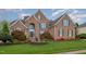 Lovely brick home features lush landscaping, a manicured lawn and a tranquil fountain at 9201 Club Hill Dr, Raleigh, NC 27617
