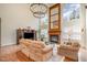 Bright living room features hardwood floors, large windows, fireplace and chandelier at 9201 Club Hill Dr, Raleigh, NC 27617