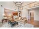 Open-concept living room with hardwood floors, fireplace and an adjacent modern kitchen at 9201 Club Hill Dr, Raleigh, NC 27617