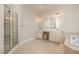 A spacious primary bathroom featuring a glass-enclosed shower, double sinks, and a large soaking tub at 9201 Club Hill Dr, Raleigh, NC 27617