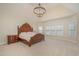 An expansive bedroom with a decorative chandelier, featuring plush carpeting and plenty of natural light at 9201 Club Hill Dr, Raleigh, NC 27617