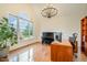 Well-lit home office with hardwood floors, vaulted ceilings and a large window at 9201 Club Hill Dr, Raleigh, NC 27617