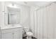Clean and modern bathroom features a white vanity, toilet, and a shower with a curtain at 1003 Canary Pepper Dr, Durham, NC 27713