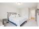 Neutral bedroom features a metal frame bed and an ensuite bathroom at 1003 Canary Pepper Dr, Durham, NC 27713