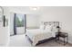 Serene bedroom with a large window, side table, and cozy decor creates a relaxing retreat at 1003 Canary Pepper Dr, Durham, NC 27713