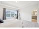 Bright bedroom features large window and an ensuite bathroom at 1003 Canary Pepper Dr, Durham, NC 27713