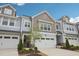 Attractive townhome featuring a welcoming entrance and well-maintained landscaping at 1003 Canary Pepper Dr, Durham, NC 27713